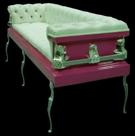 A Pink And White Couch Sitting On Top Of A Table