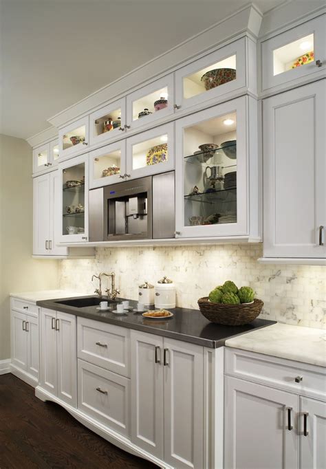 Adding bright white paint to your kitchen cabinets can transform and brighten the entire room, without breaking the bank. Amazing White Glass Kitchen Cabinets Contemporary with ...