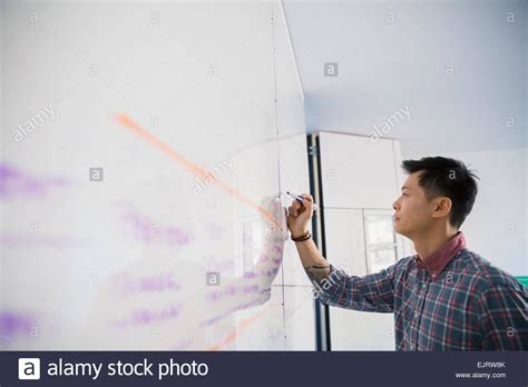 Businessman Writing On Whiteboard Stock Photo Alamy