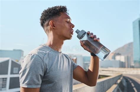 City Fitness And Man Drinking Water After Running In Street Thirsty