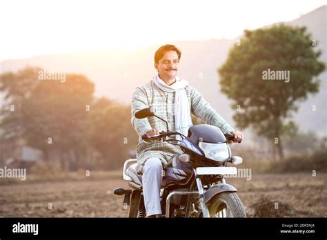 Happy Rural Indian Man Riding On Motorcycle In Village Stock Photo Alamy