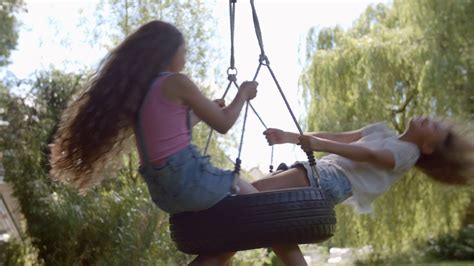 Two Girls Playing On Tire Swing In Garden Stock Footage Sbv 310818079 Storyblocks