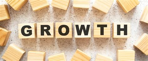 Premium Photo The Word Growth Consists Of Wooden Cubes With Letters