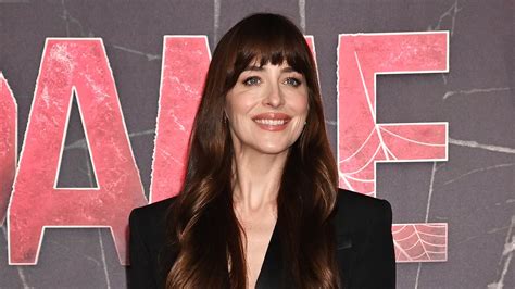 Dakota Johnson Teases A Glimpse Of Her Toned Midriff In A Cropped Black Blazer And Chic Midi