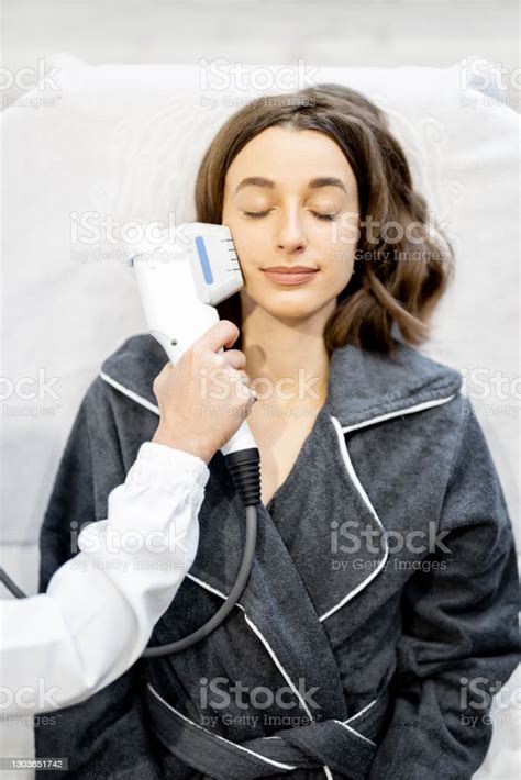 Woman On Ultrasound Face Lifting Procedure In Cosmetology Salon Stock