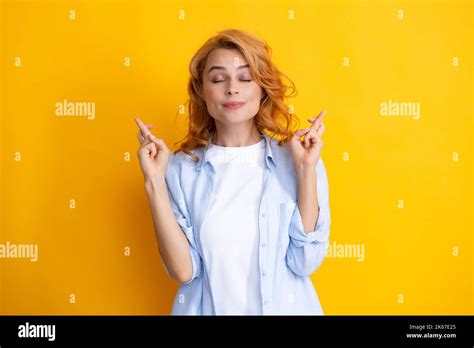 Portrait Of Funny Woman With Crossed Fingers For Good Luck Isolated