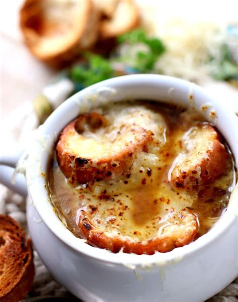 French Onion Soup In A White Bowl With Croutons And Cheese On Top Onion