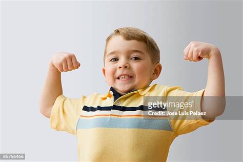 Kid Flexing Muscle Stockfotos En Beelden Getty Images