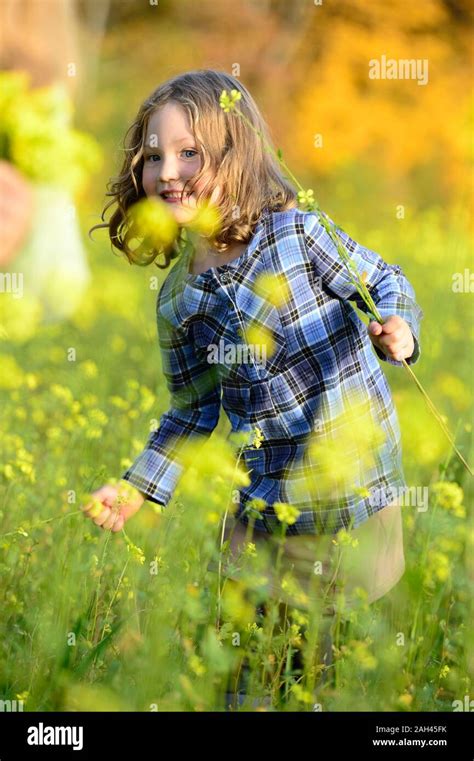 Girl Picking Flowers Stock Photo Alamy