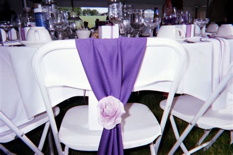 If you're planning a lavish event, chair covers from your chair covers make an excellent choice because our wholesale tablecloth and chair cover company. Purple fabric folded over the chairs at the head table. I ...