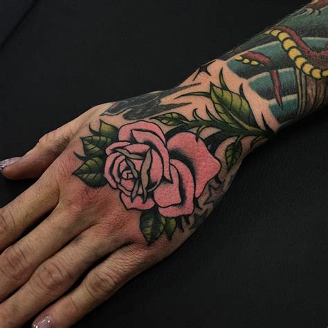 If you happen to see a man with a rose tattoo, you can be certain that there is someone in his life, for whom he cares deeply. Pink rose tattoo on the hand - Tattoogrid.net