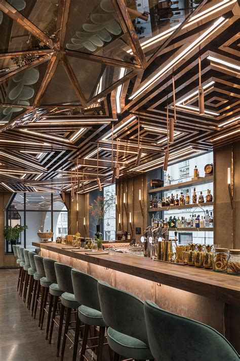 Luxury Bar Design Featuring Geometric Brass Ceiling Panels And Lighting