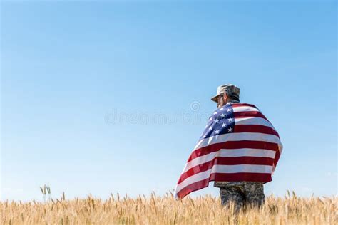 Soldier In Cap And Military Uniform Holding American Flag Stock Image