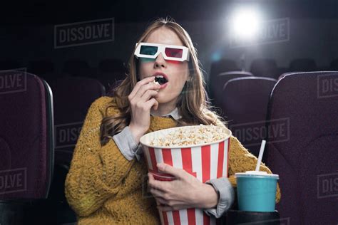 Excited Woman In 3d Glasses Eating Popcorn And Watching Movie In Cinema