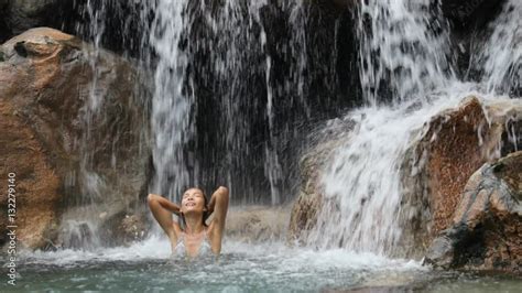 Sexy Beautiful Multicultural Woman Bathing Under Waterfall In Bikini On