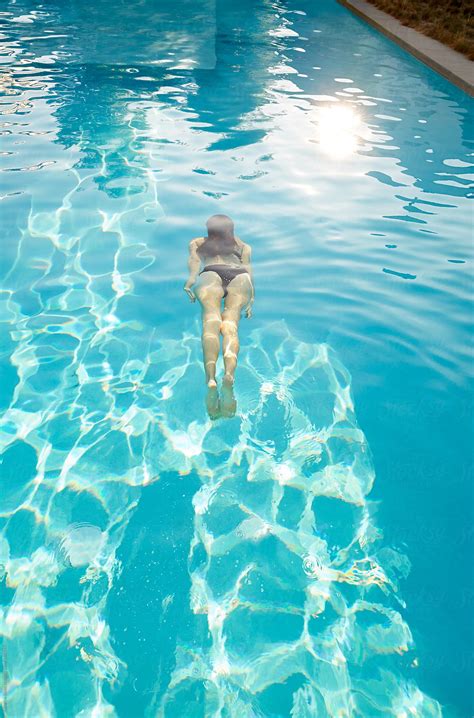 Woman Floating In Water In Swimming Pool By Stocksy Contributor Trinette Reed Stocksy