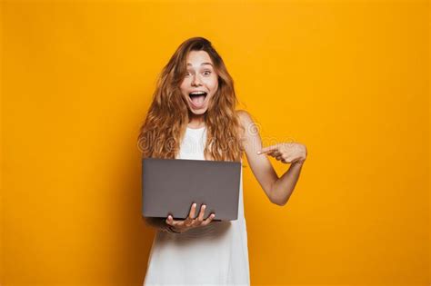 Portrait Of A Cheerful Young Girl Holding Laptop Computer Stock Image