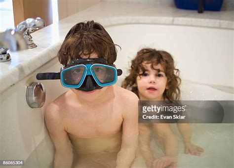 Brother And Sister Playing In Bath Tub Photos And Premium High Res