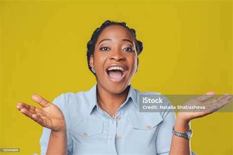 Beautiful African American Girl With Dark Hair Smiles Happily And Spreads Her Arms In Different
