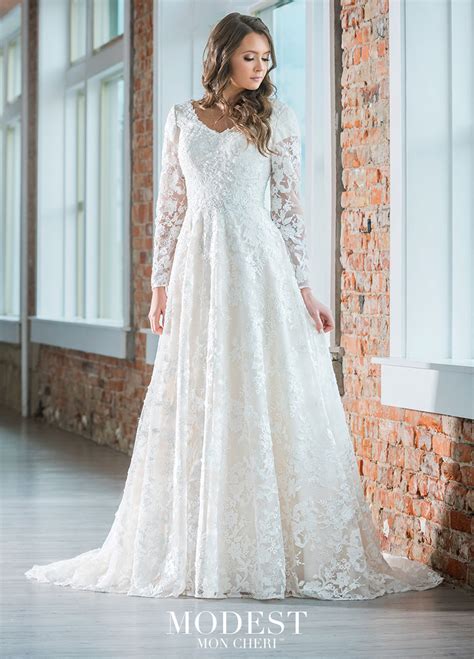 Lace Flows Over A Stretch Lining To Create An A Line Silhouette In This Modest Bridal By Mon