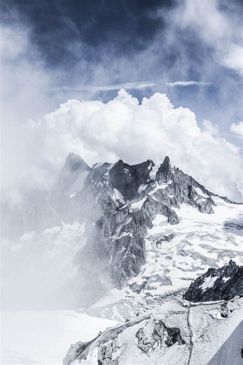 Dramatic Mountain Peaks Covered With Snow In Fog · Free Stock Photo