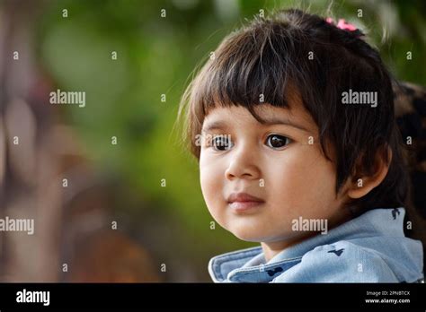 Closeup Of Cute Indian Baby Girl Looking Right Horizontal Outdoor