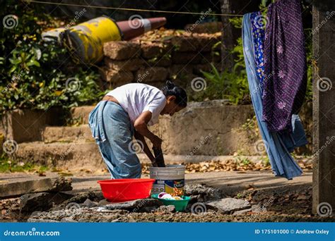 Indian Woman Hand Washing Clothes Outside In Bucket Editorial Image