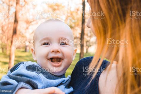 Sweet Baby Boy Is One Year Old Cute Kid With Blue Eyes In Blue Sweater