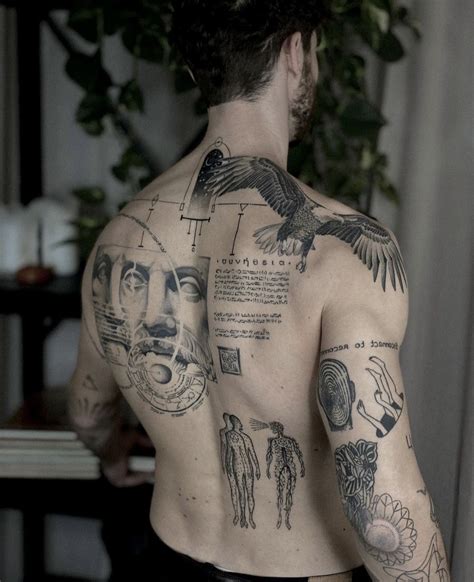 A Man With Many Tattoos On His Back