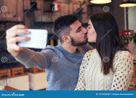 Couple Making Selfie While Kissing At Cafe Stock Photo Image Of Candid Lifestyle