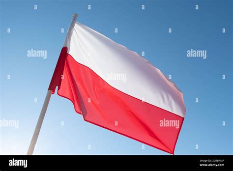 Flag Of Poland On Blue Sky Background Polish Flag Waving In Wind And