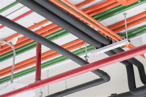 Colorful Electrical Conduits Pipe System Installed On The Ceiling Stock