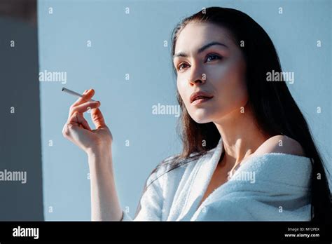 Pensive Young Woman Smoking Cigarette Hi Res Stock Photography And
