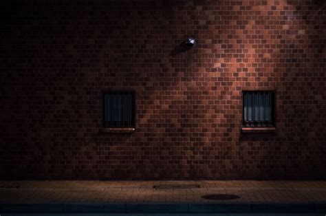 Red Brick Wall Under Street Light In Midnight Stock Photo