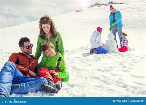 Two Families Having Fun In The Snow In Mountain Stock Photo Image Of