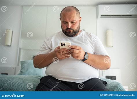 Fat Bearded Bald Guy With Smartphone Chatting Dials Number Types