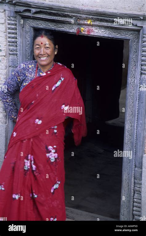 asia nepal kathmandu valley kirtipur hindu woman in sari standing in intricate carved wood