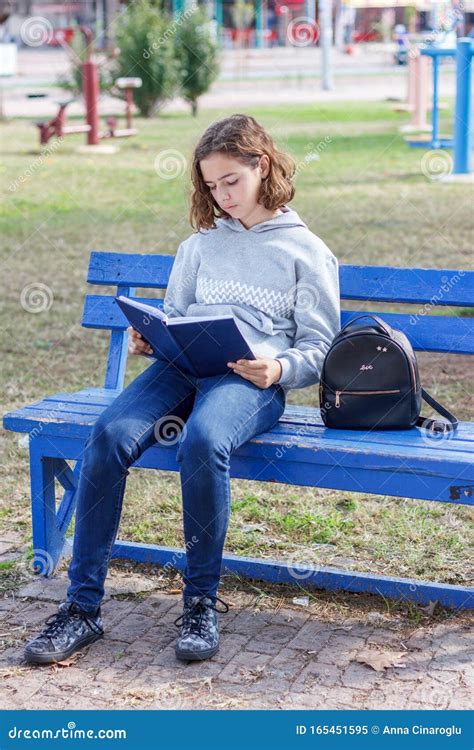 Beautiful Curly Teen Girl Reading A Book In A Park On A Bench Stock Image Image Of Girl Cute