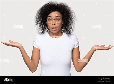 Confused Doubtful Baffled Black Woman Shrugging Looking At Camera Stock