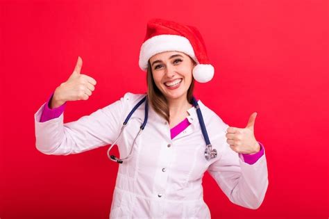 Premium Photo A Smiling Nurse In A Santa Claus Hat Shows The Class