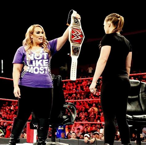 Raw Woman Champion Nia Jax Holding Up The Belt Against Ronda Rousey On