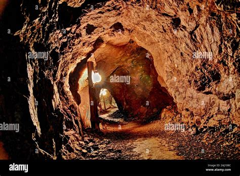 Illuminated Mine Shaft Tunnel With Winding Path Ominous Mine Shaft