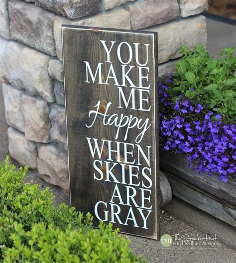 A Wooden Sign That Says You Make Me Happy When Skies Are Gray Next To