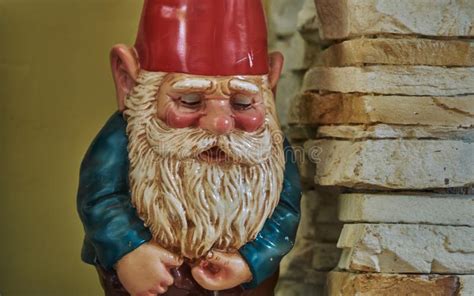 A Close Up Of A Garden Gnome With A Red Hat And White Beard Stock Image