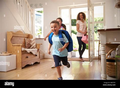 Excited Children Returning Home From School With Mother Stock Photo Alamy