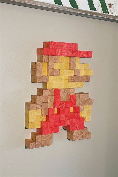 A Piece Of Wood That Has Been Made To Look Like An Old Video Game Character