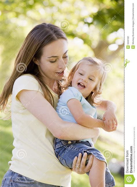 Mother Holding Daughter Outdoors Stock Photo - Image of happy, month 