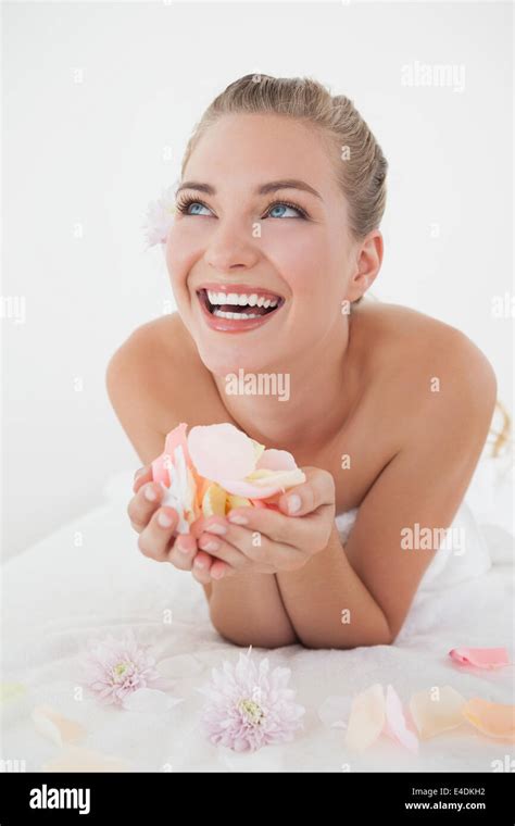 Pretty Blonde Lying On Massage Table Holding Petals Stock Photo Alamy