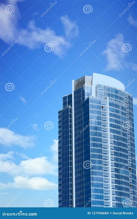 Blue Glass Tower Rising From Older Buildings Stock Photo Image Of