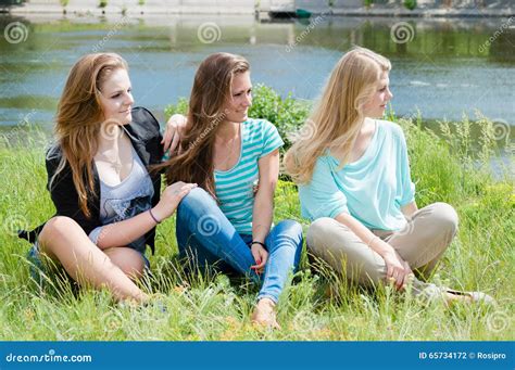 Three Relaxing Beautiful Female Sit On Green Grass Stock Photo Image